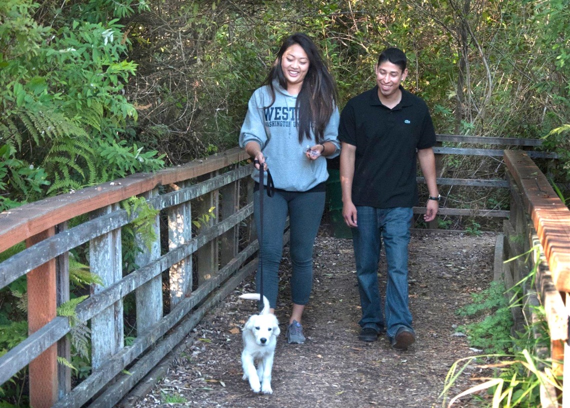 Couple walking a dog at Scriber Lake Park