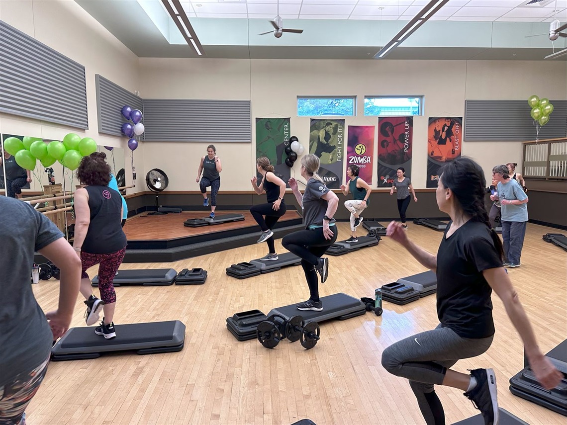 Lady leading aerobics using step
